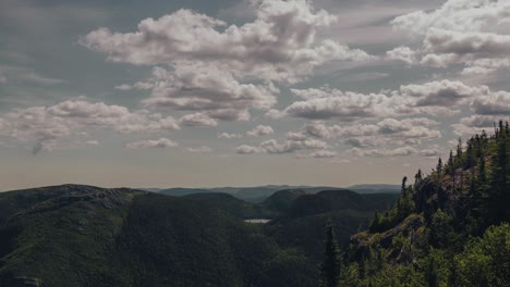 White-Clouds-Moving-Above-The-Beautiful-Mount-Of-The-Dome-In-The-Region-Of-Charlevoix,-Quebec,-Canada-At-Summer