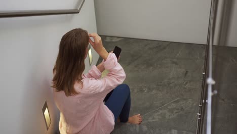 Caucasian-woman-using-smartphone-in-hotel