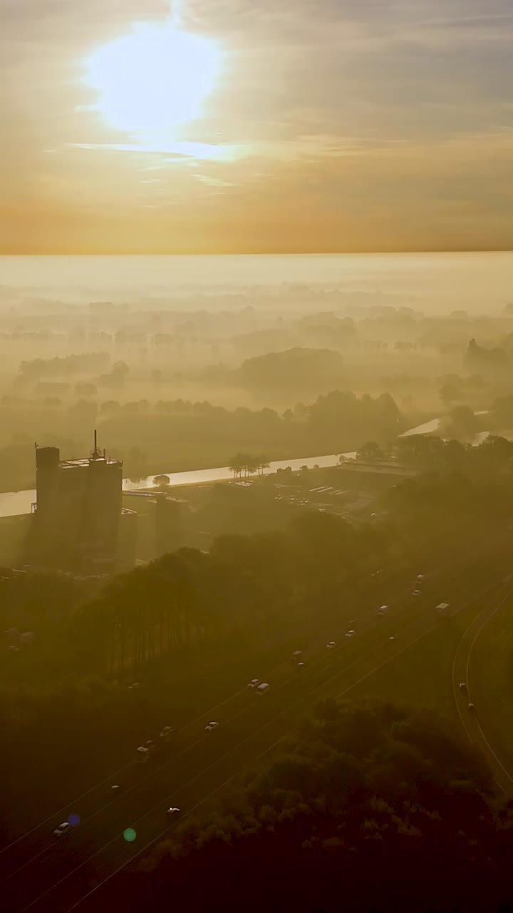 Sunrise/Sunset over Foggy Landscape with Highway and River