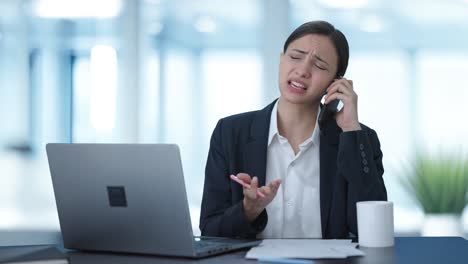 frustrated indian female manager shouting on mobile phone