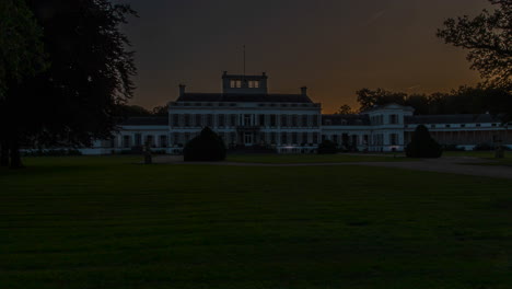 time lapse of the sun rising behind a beautiful white palace in the netherlands - slow zoom out