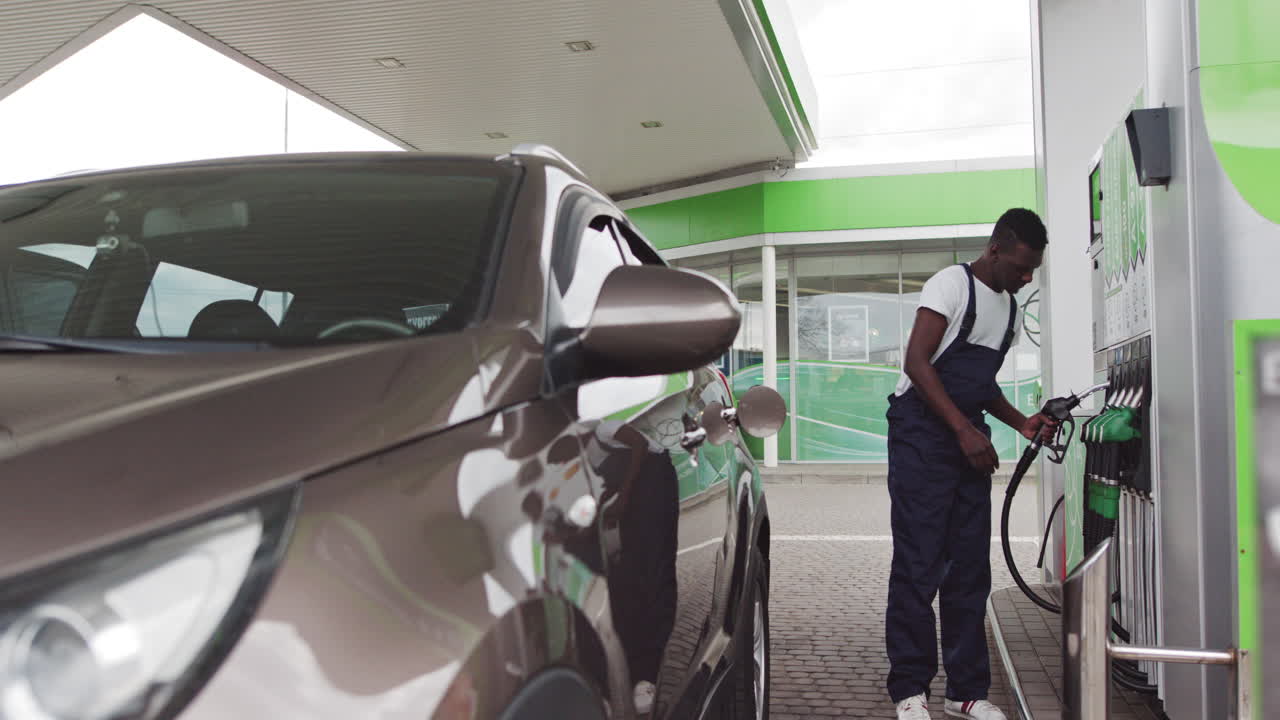 Man Filling Up Car at Gas Station