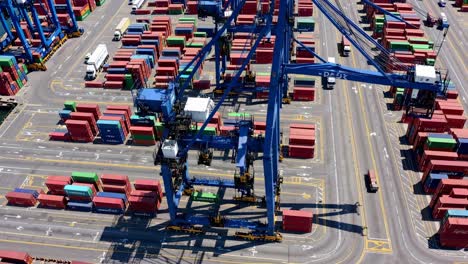 aerial view of a bustling shipping port with colorful containers and cranes