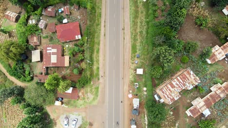 Aerial-view-of-cars-and-people-at-a-Open-Air-Market,-in-Africa---reverse,-drone-shot