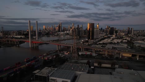 Aerial-toward-Melbourne-city-skyline-dusk-establishing-shot,-Australia