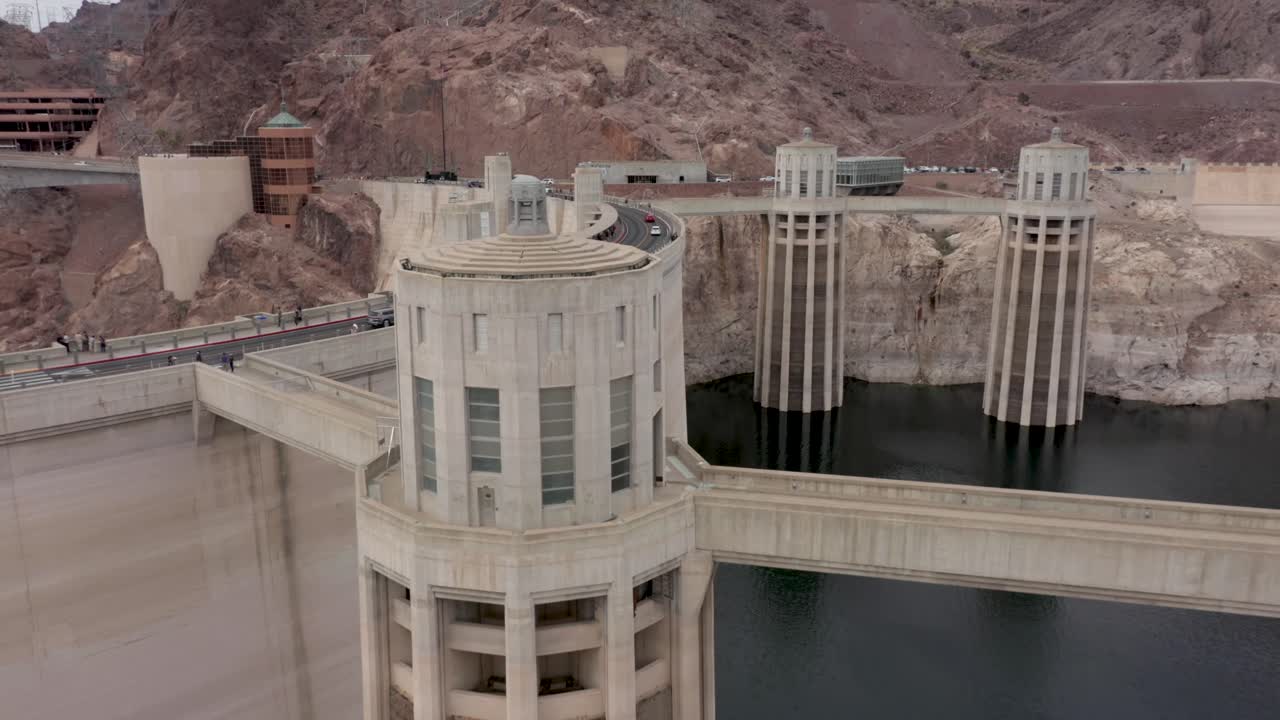 Aerial view of the Hoover Dam and the intake towers with traffic on the bridge