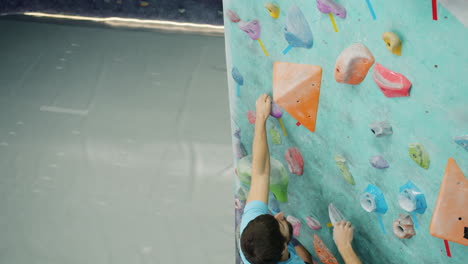 man rock climbing on a climbing wall