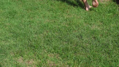 person walking barefoot on a lawn over time