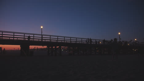 purple and orange skies over seal beach pier