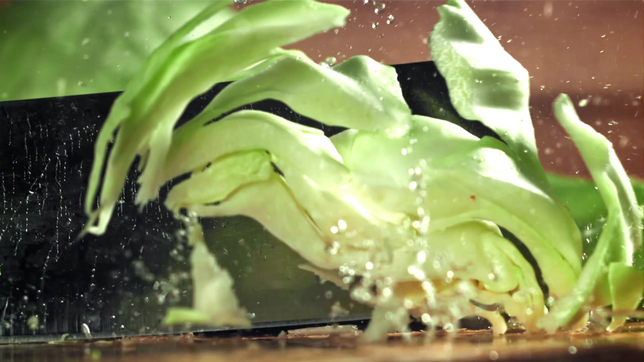 Fresh Cabbage Being Sliced by a Knife in Slow Motion