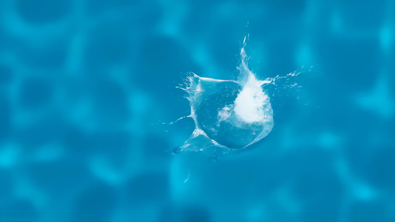 Dynamic Water Splash and Ripples in Blue Liquid