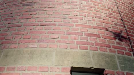 the shadow of a flying drone on a brick wall