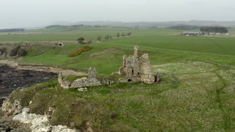 An-aerial-view-of-Newark-Castle-on-the-Fife-coastal-path,-Scotland