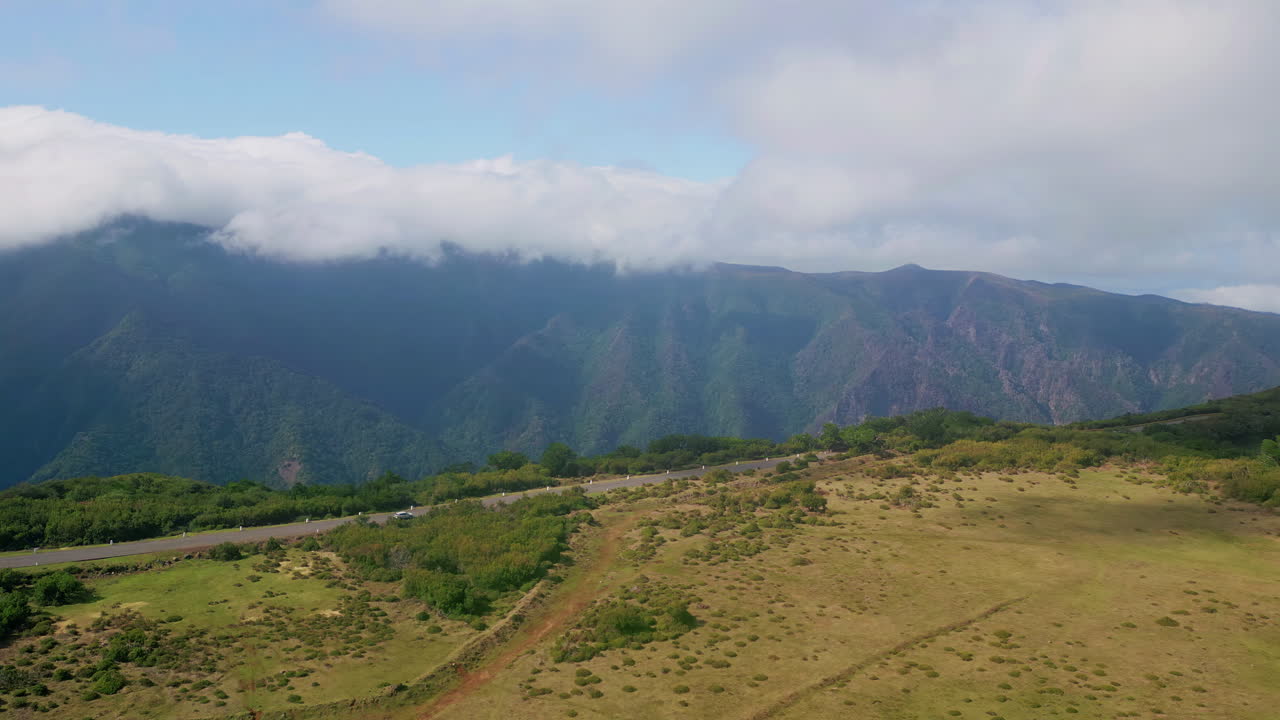 Mountain road landscape with clouds and trees
