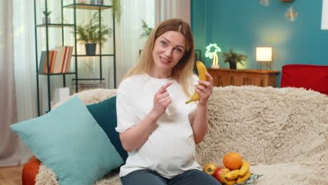pregnant woman shows banana vitamin vlog taps belly shares good snack tips during fun baby journey
