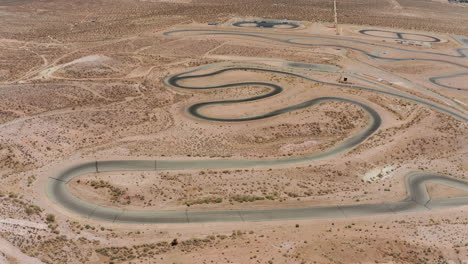 a huge complex of racetracks with cars on one of the courses - aerial view