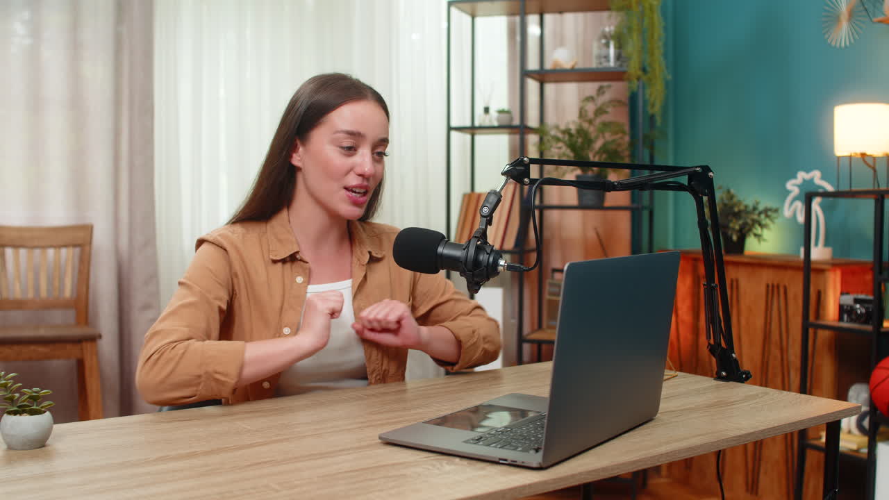 Young woman live streaming with studio microphone confidently teaching audience practical tips