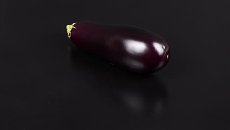 eggplant on black. extrem close-up. top view. loop motion. rotation 360.
