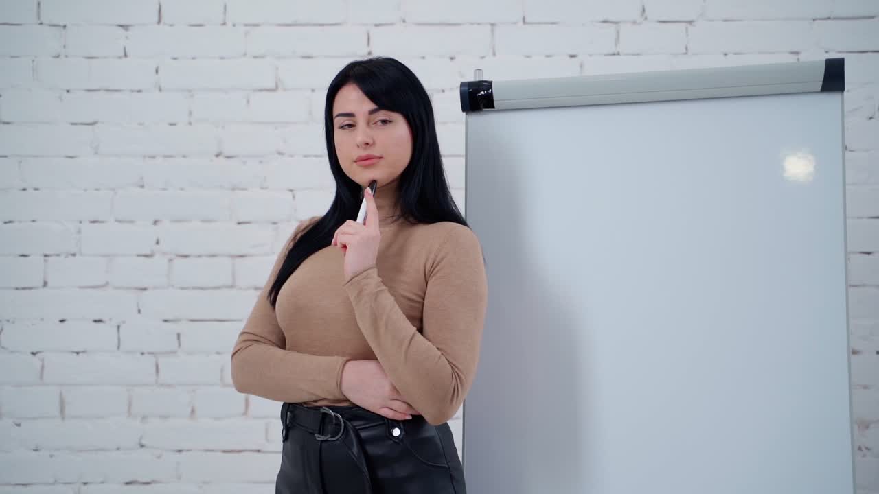 Woman near board. Portrait of young beautiful business woman in the office