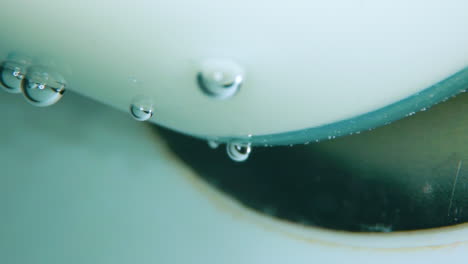 air-bubbles-on-white-plastic-and-running-clear-water-flow