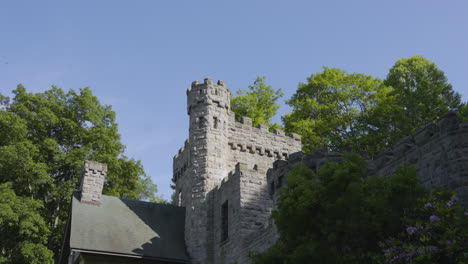 tilt-shot-up-the-tower-of-a-stone-casyle-on-a-bright-sunny-day