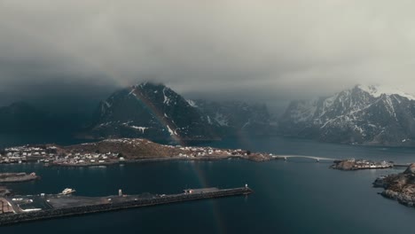 rainbow in the coast of reine village in winter in norway. - aerial shot