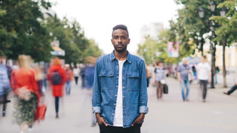 man in a denim shirt on a city street