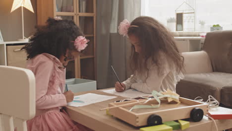 mixed-race girls drawing and having fun