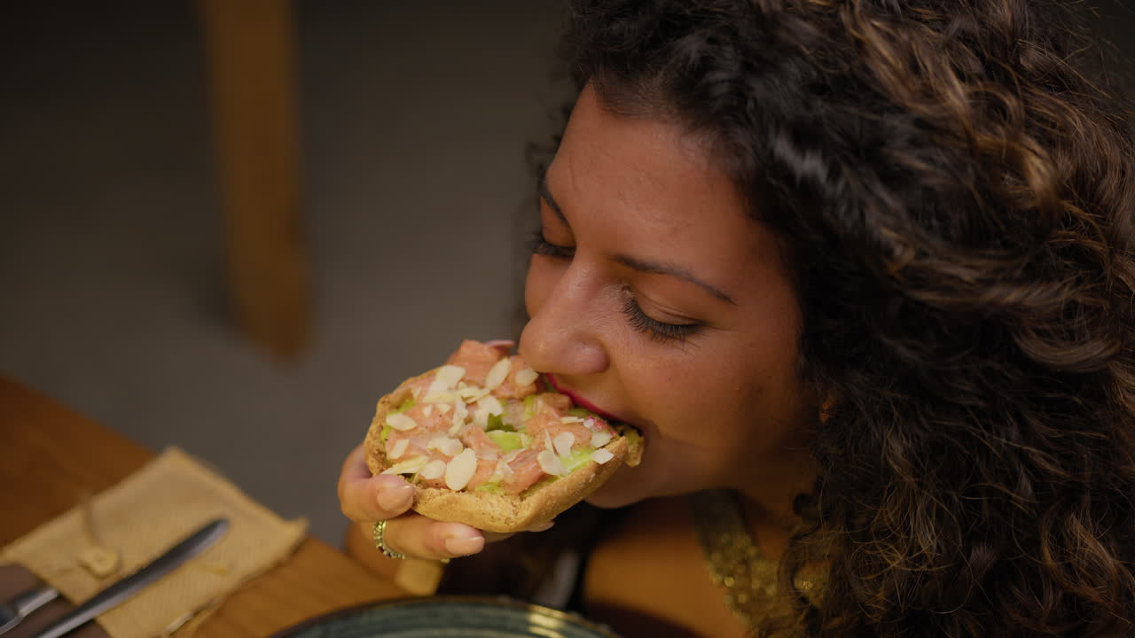 Woman Eating An Italian Bruschetta At The Restaurant For Dinner