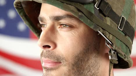 Soldier-standing-in-front-of-American-flag