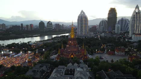 Buddhist-Temple-and-City-Buildings-in-Chinese-Touristic-Travel-Destination-of-Xishuangbanna---Aerial