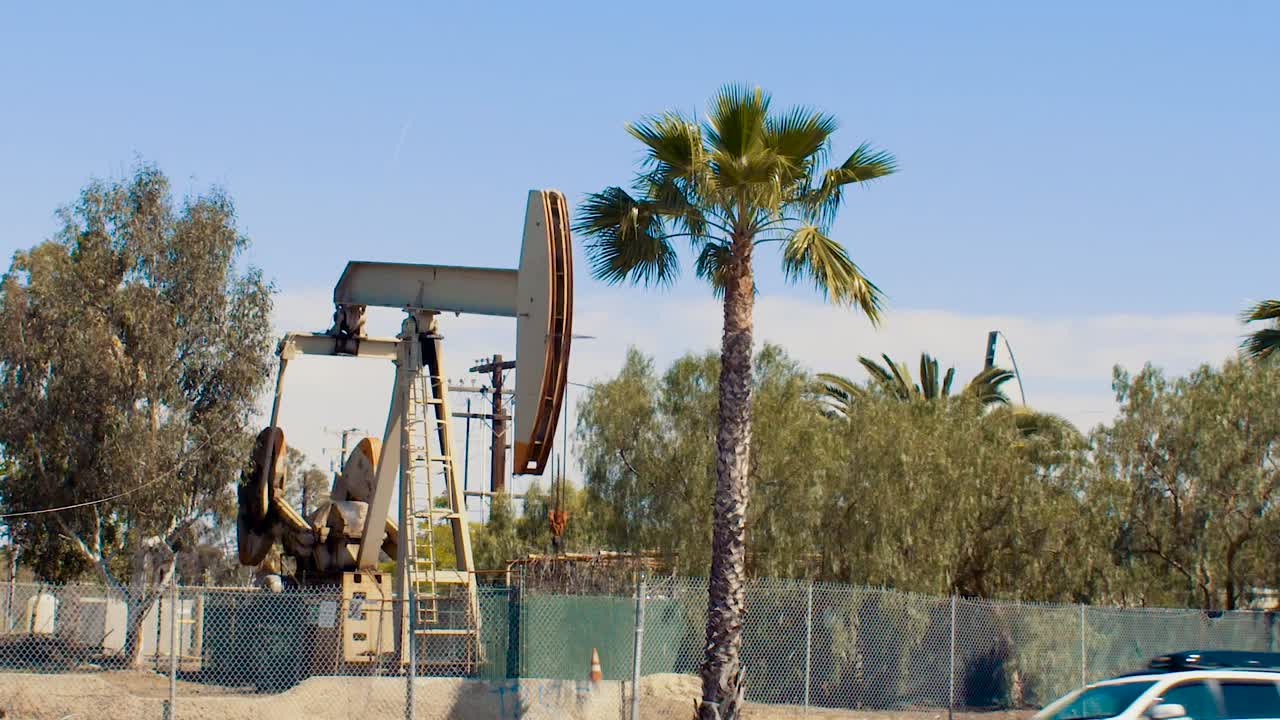 Oil pump Long Beach California with traffic in front