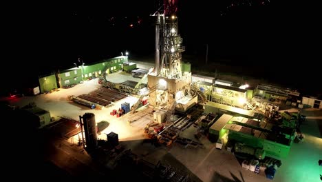 oil platform with night lights - aerial drone shot