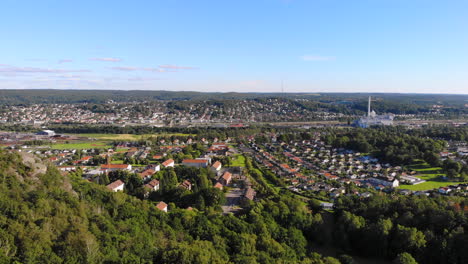 suburb swedish area east of gothenburg, scenic aerial drone view above forest hill, sweden, forward, day