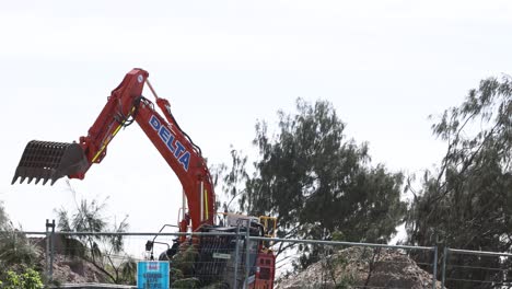 excavator moving debris at construction site