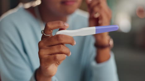 woman holding a pregnancy test