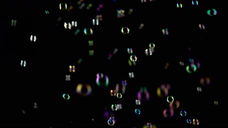 rainbow soap bubbles fly black background rainbow soap bubbles fly in the air and burst black backround