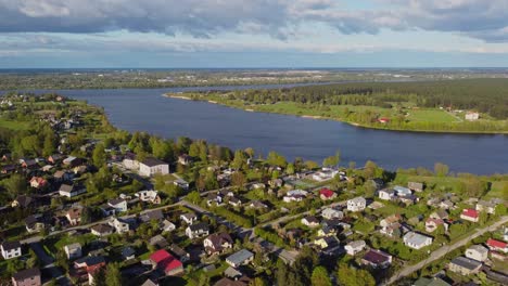 katlakalns spring residential area lies beside a wide river, surrounded by greenery and calm.