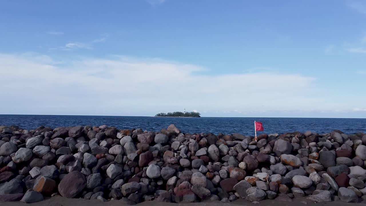 Aerial shot fordward moving flying over stone pier to reveal an island with trees, in the Gulf of Mexico, america landscape