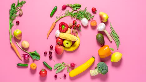 Vegetables-and-fruits-movement,-stop-motion.-Organic-fresh-vegetables-animation-on-a-pink-background,-4k-video