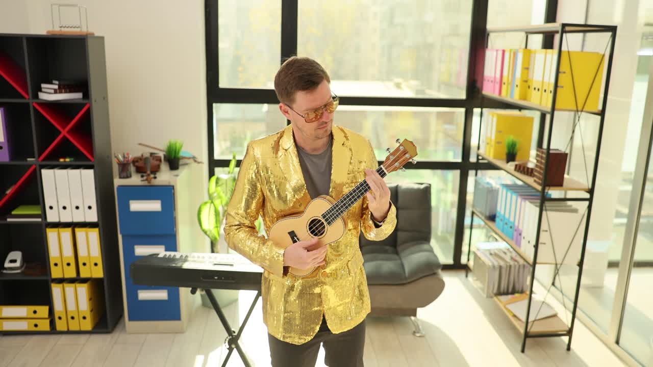 Man playing ukulele in office