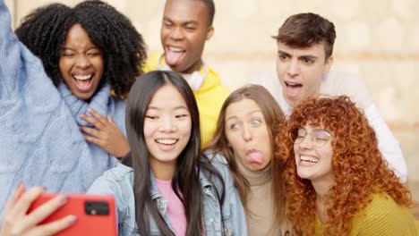 chinese girl taking a selfie with diverse friends outdoors