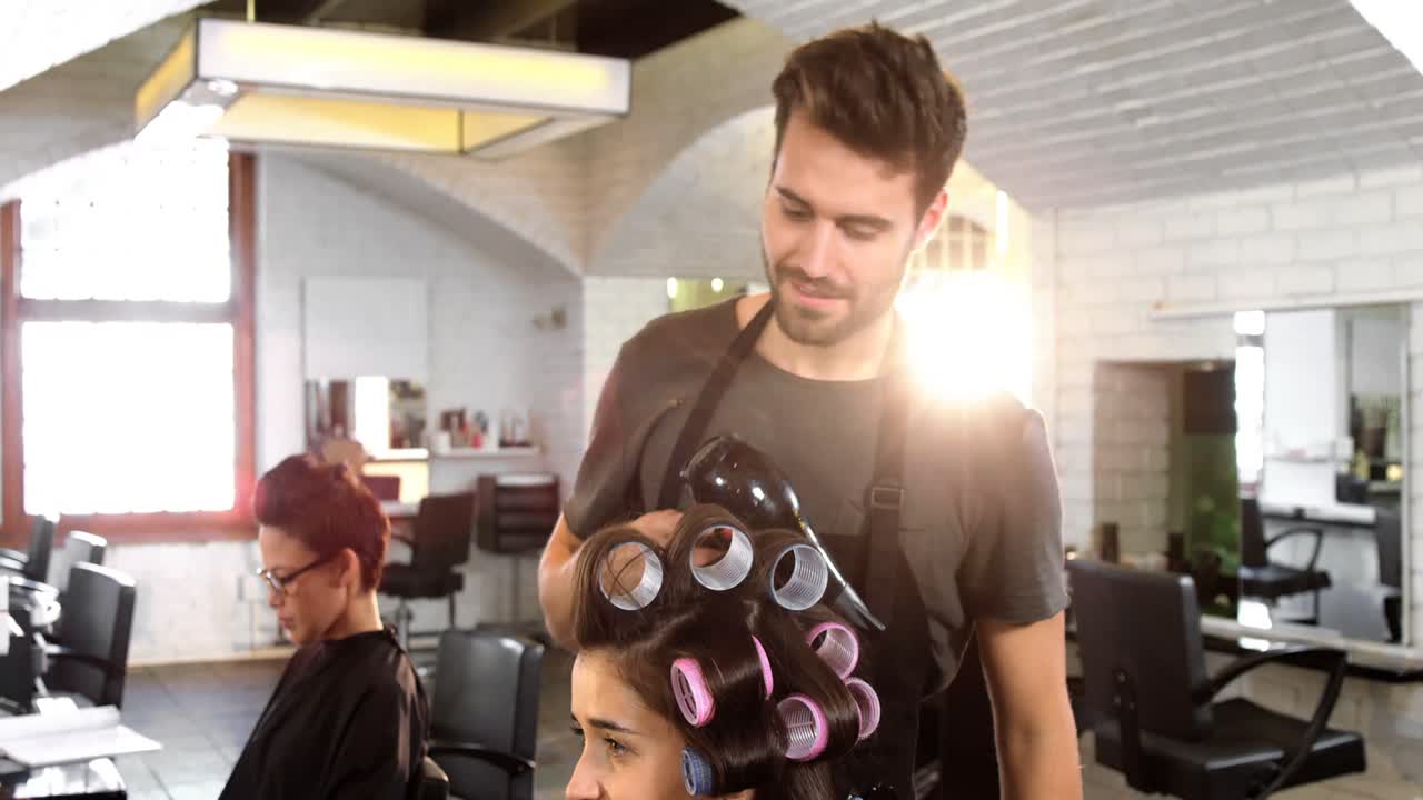 Parrucchiere uomo che acconcia i capelli di un cliente