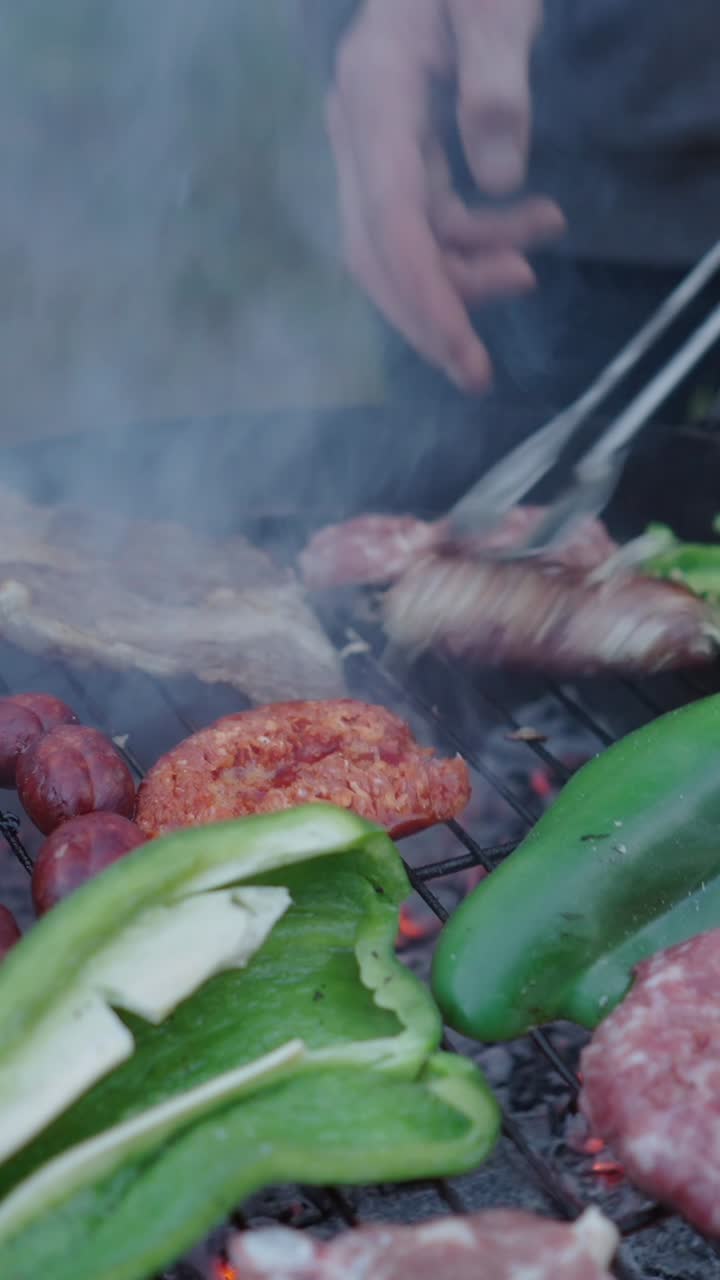 Barbecue with various meats and vegetables grilling