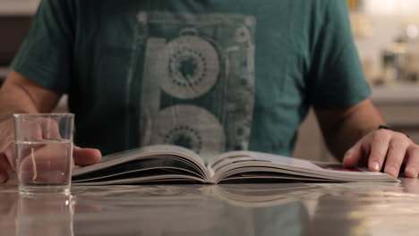 male hand flipping book pages during reading