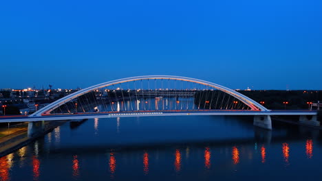 beautiful road bridge over the danube in the capital of slovakia. lights are on in the appolo bridge in bratislava at dusk time