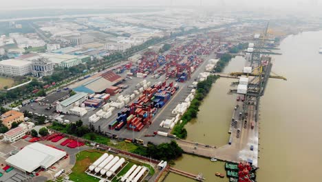 Top-aerial-view-of-stacked-container-terminal-on-Song-Sai-Gon,-Vietnam