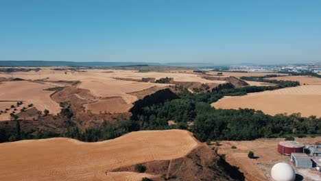 aerial view of a rural landscape with dry fields and a valley