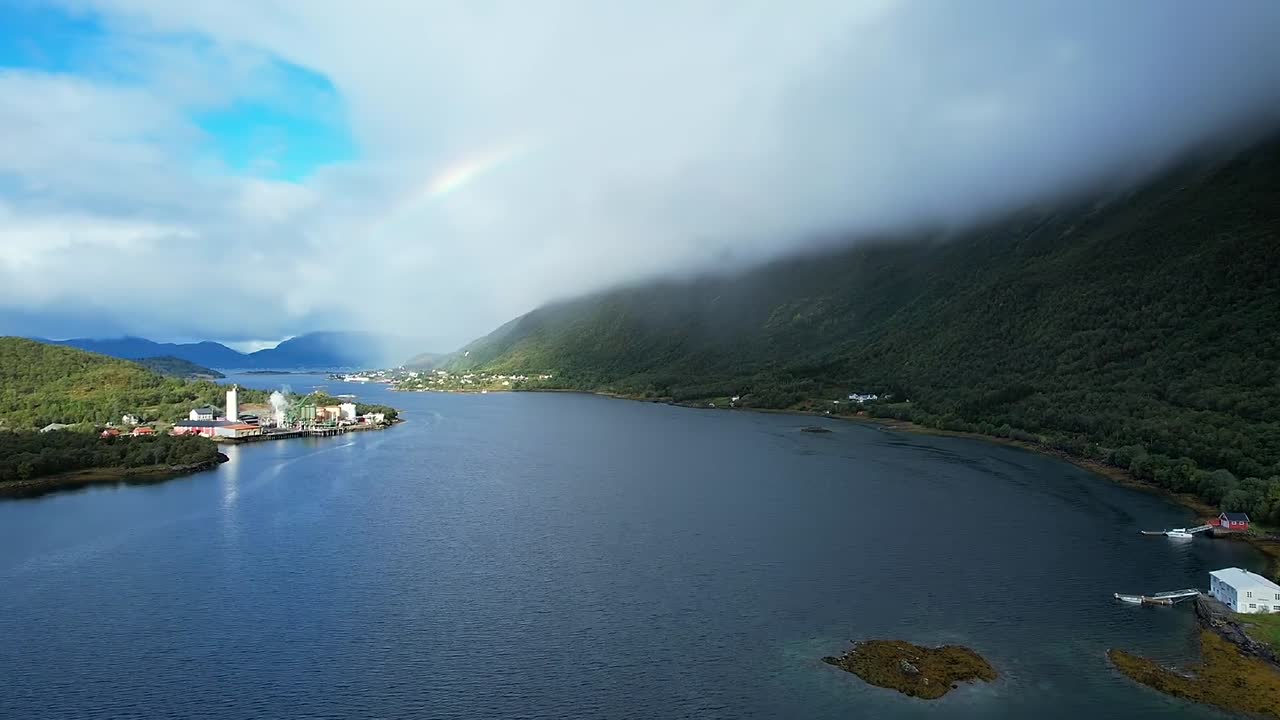 세이더피오르드의 아리엘 뷰: 무지개와 함께 구름이 가득한 여름 날, 오래된 공장