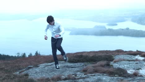 a happy young man dancing electro swing in the rain